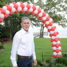 Celebrating with Constantine Toumbis below a balloon arch